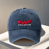 Gorra de béisbol ajustable del proyecto Nude - Ligera, lavable a mano, cierre de snapback, negra con diseño de texto rojo cereza y blanco, perfecta para viajes al aire libre y Halloween, accesorios de Halloween | Diseño juguetón | Gorra ligera