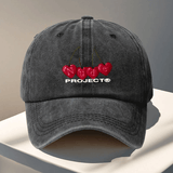 Gorra de béisbol ajustable del proyecto Nude - Ligera, lavable a mano, cierre de snapback, negra con diseño de texto rojo cereza y blanco, perfecta para viajes al aire libre y Halloween, accesorios de Halloween | Diseño juguetón | Gorra ligera